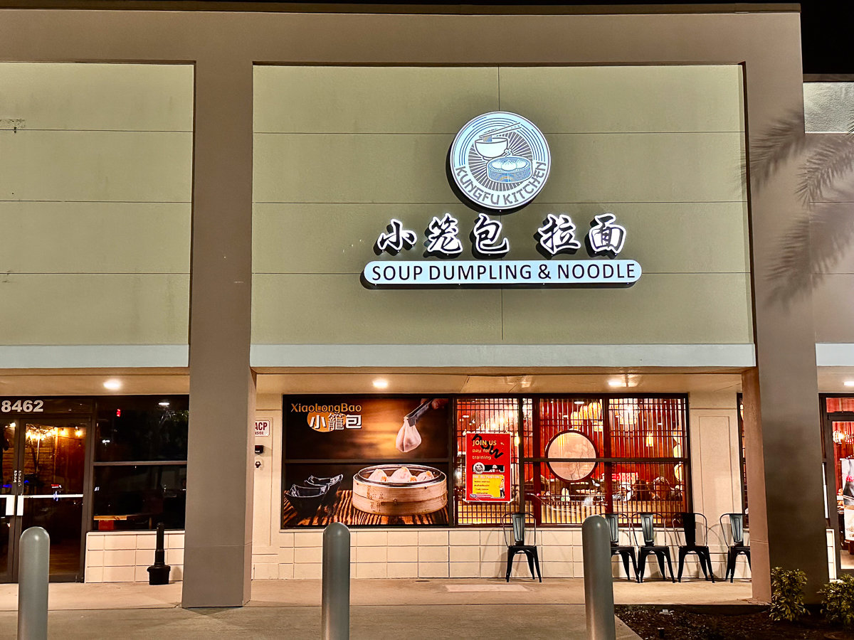 front of restaurant with kung fu kitchen sign on a white wall